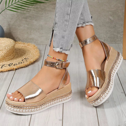 Gold open-toe wedge sandals with ankle strap and metallic finish