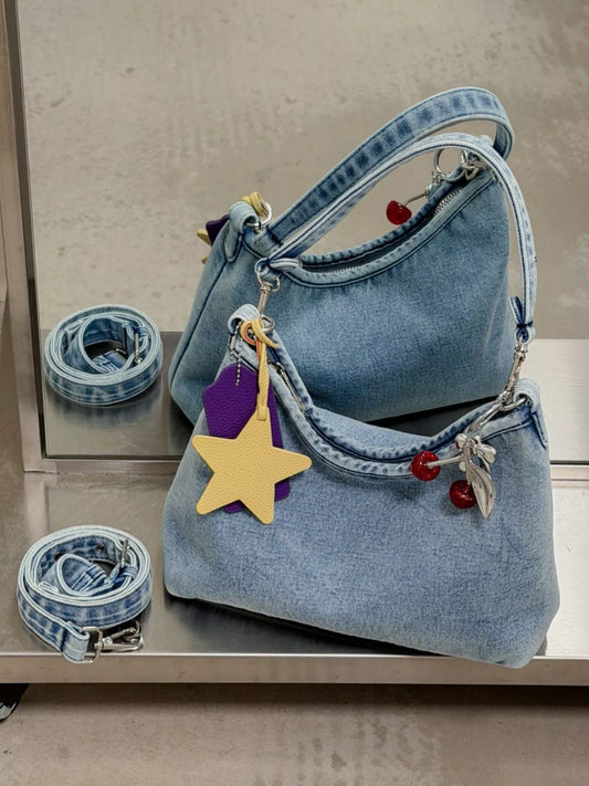 Medium light-blue denim shoulder bag with gold star charm and dangling red beads