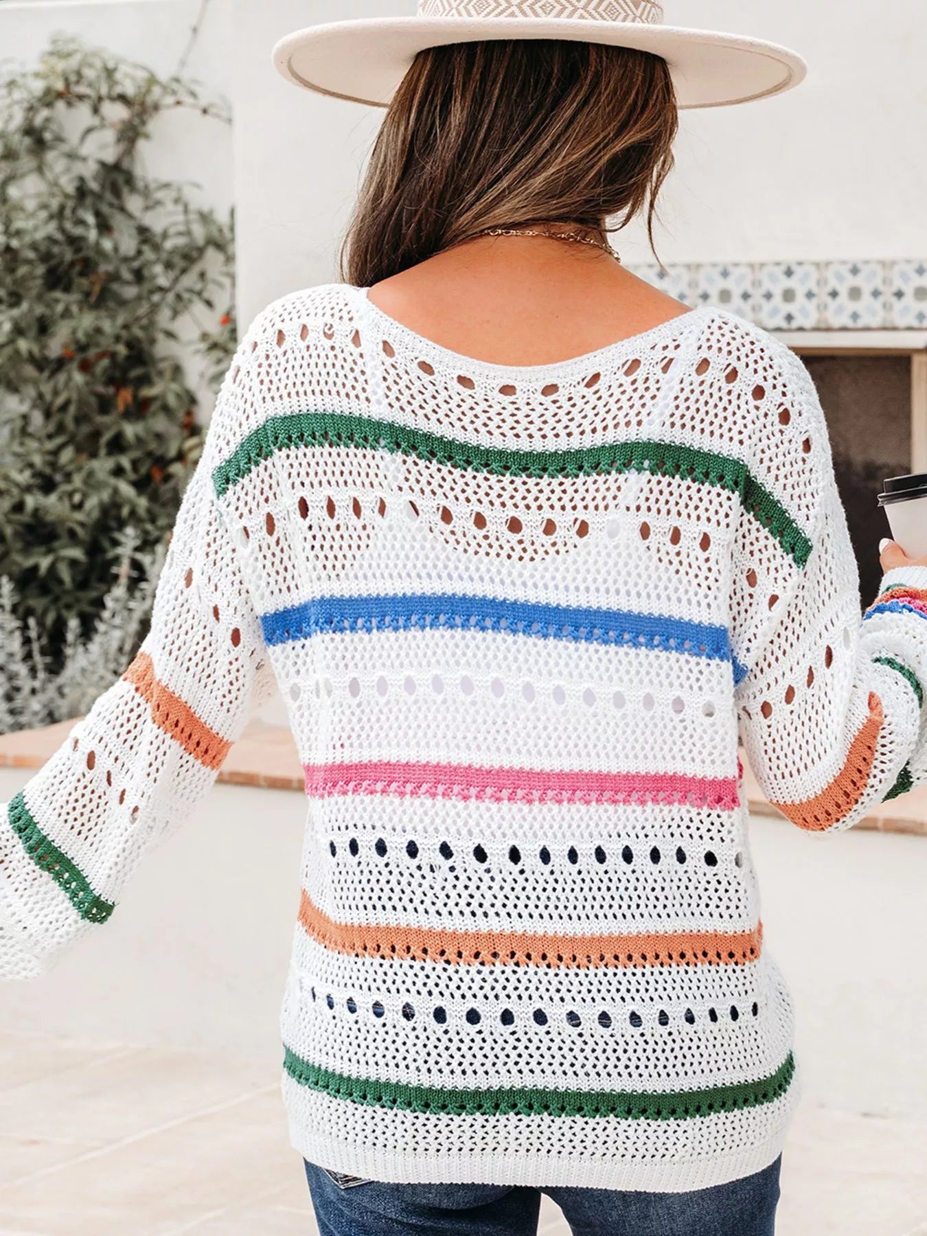 White pointelle knit sweater back view with multicolor striped bands