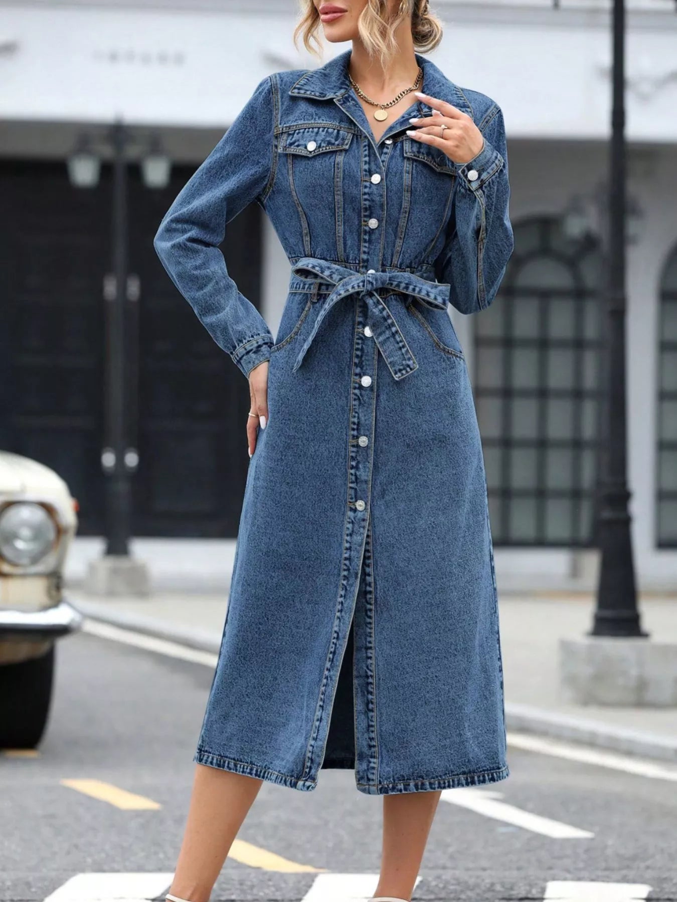 Light blue denim belted long-sleeve dress with button front and wrap-style waist.