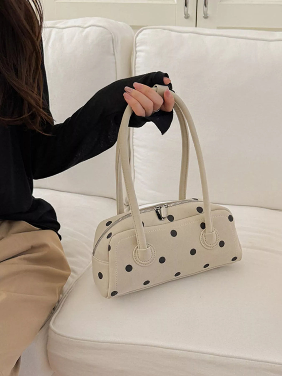Off-white polka dot shoulder bag with top handles and small zipper pocket detail