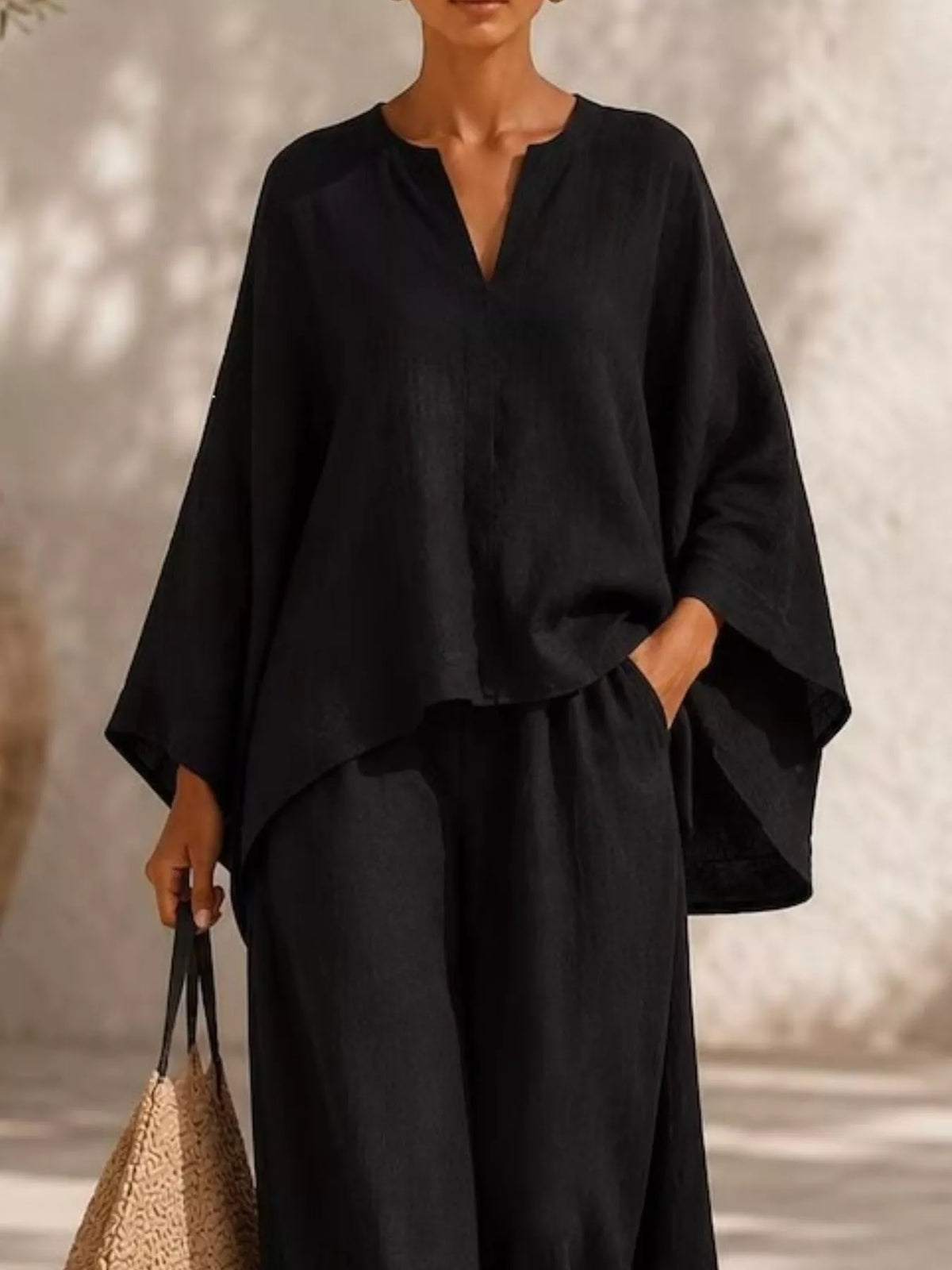 Black long-sleeve V-neck top and wide-leg pants set, draped kaftan-style sleeves