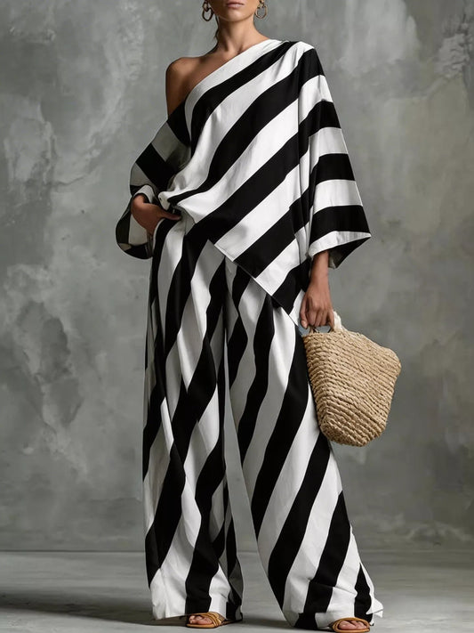 Black and white striped one-shoulder top with wide-leg pants set, draped sleeve