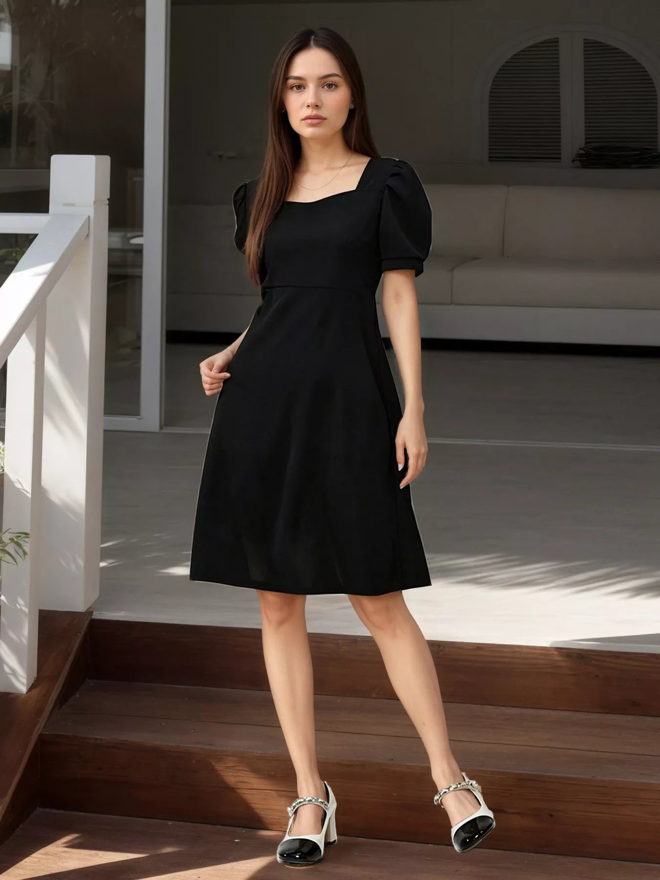 Black puff sleeve mini dress with square neckline and A-line skirt