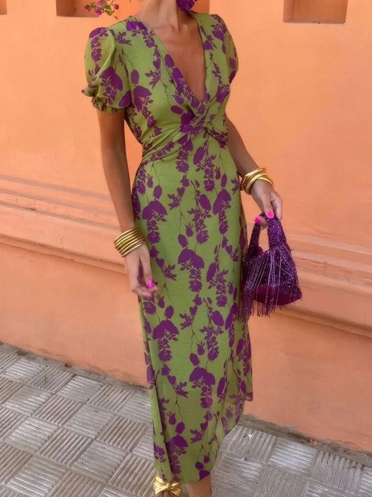 Moss green printed midi dress with purple floral pattern, plunging V-neck and puff sleeves