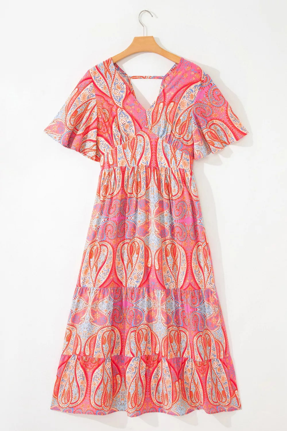 Burnt coral paisley V-neck boho dress on hanger, short ruffle sleeves, tiered skirt