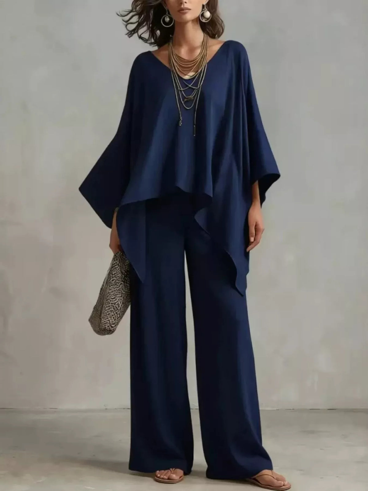 Navy blue V-neck top and wide-leg pants set with draped sleeves and asymmetrical hem