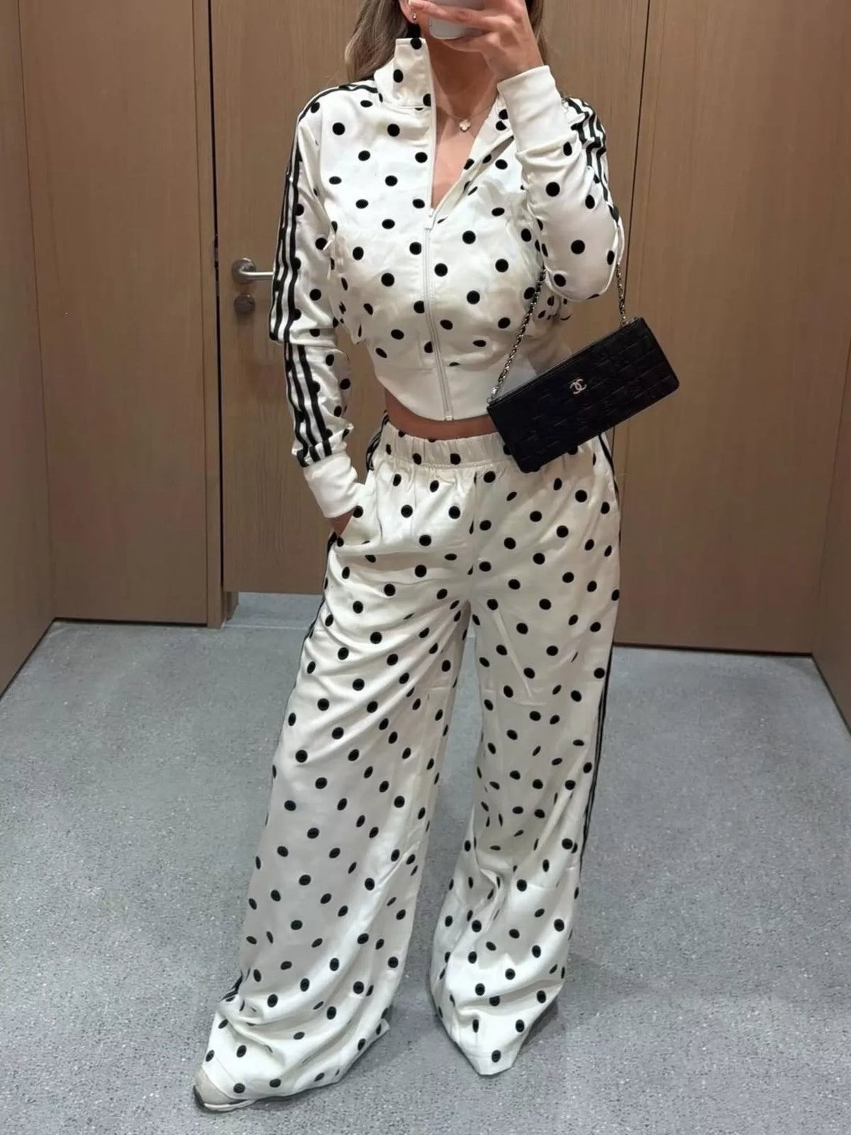 White polka-dot tracksuit set with zip front jacket and striped sleeves, wide-leg pants