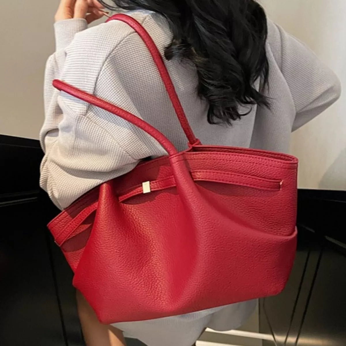 Red PU leather shoulder bag with top handles and inner zip pocket visible at opening