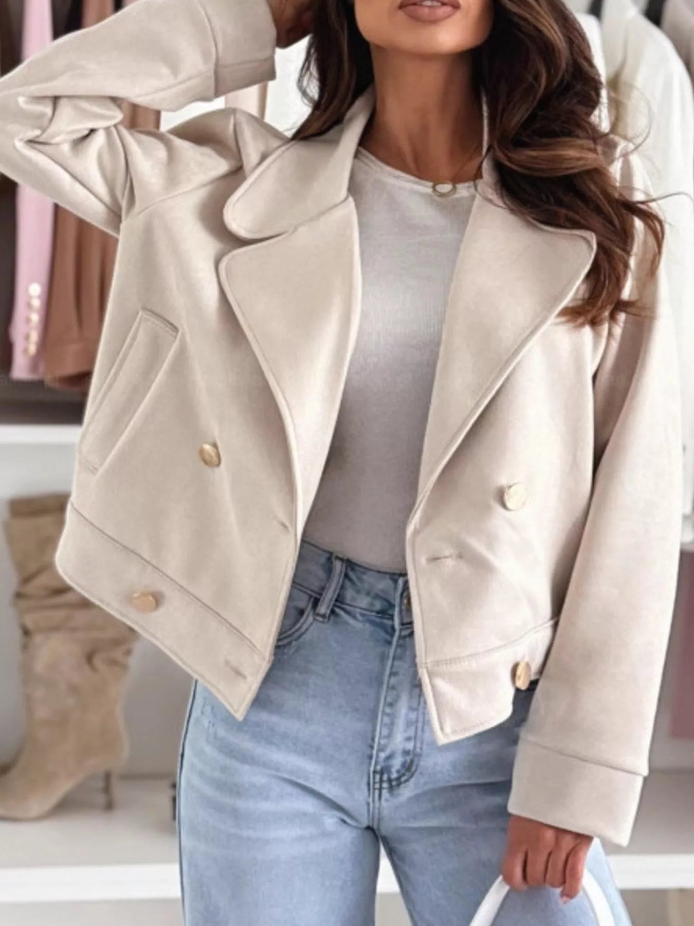 Beige cropped double-breasted jacket with lapels, gold buttons, and flap pockets
