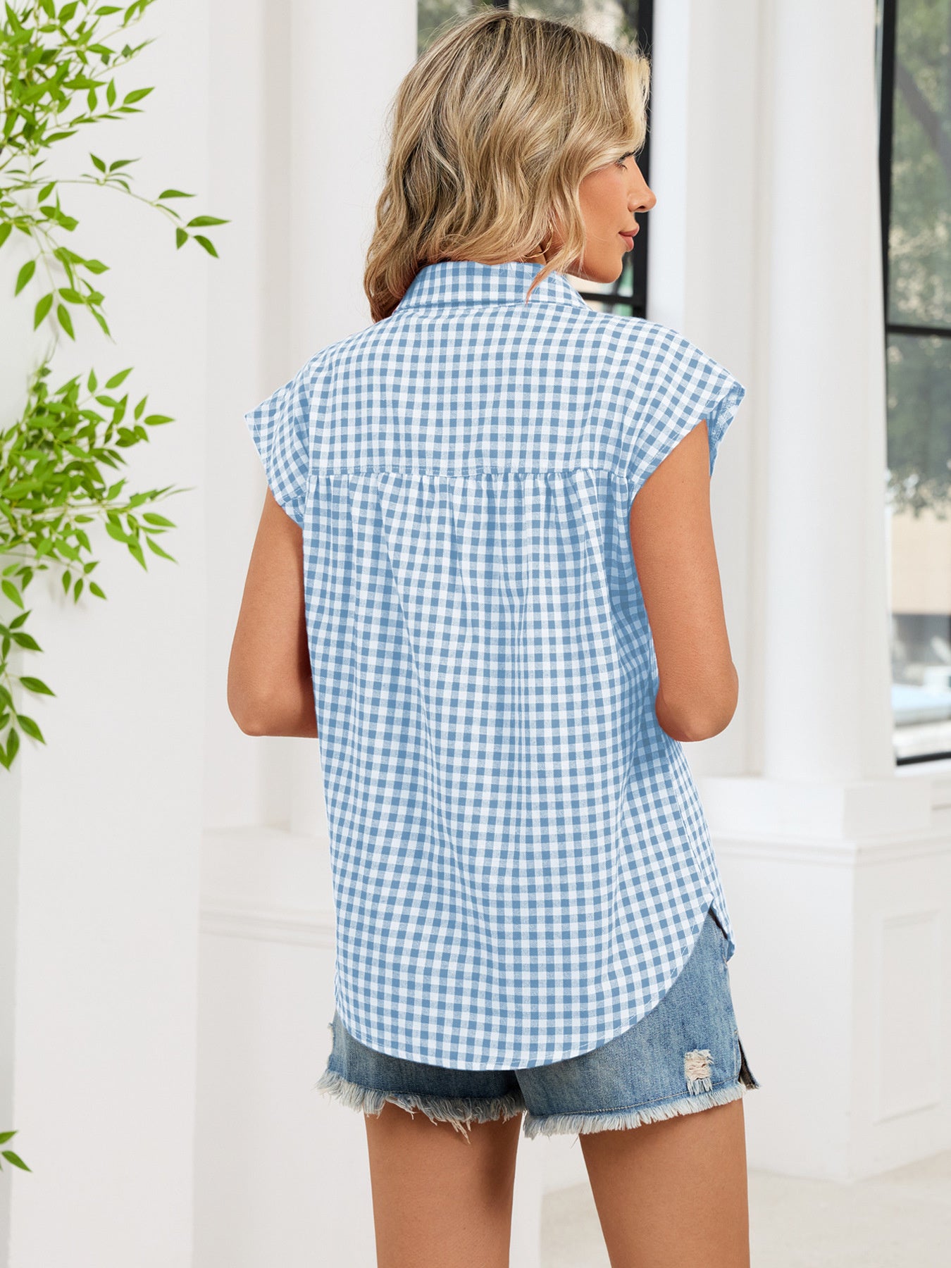 Blue plaid cap-sleeve button-up shirt from the back, showing yoke and collar
