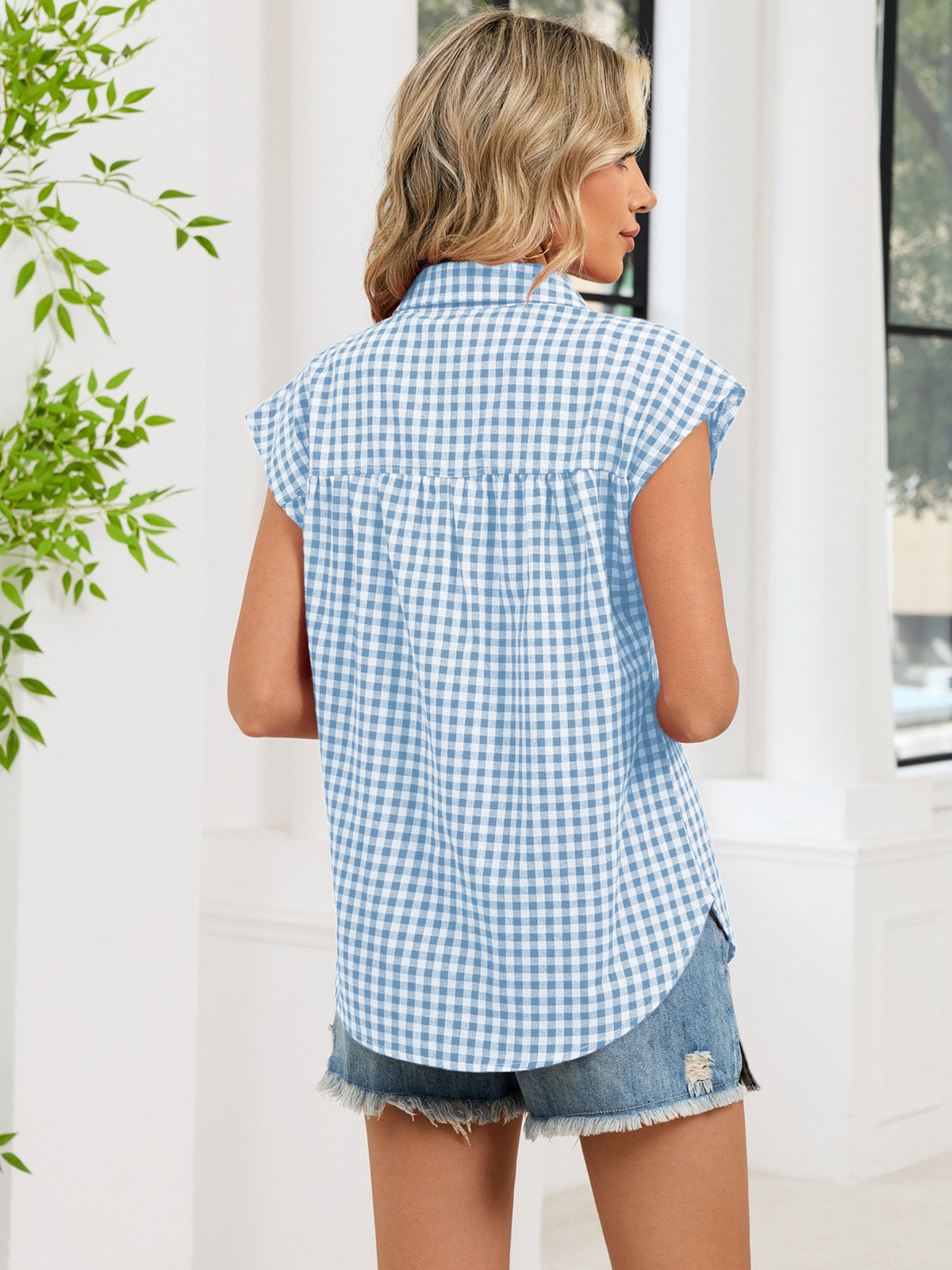 Blue plaid cap-sleeve button-up shirt from the back, showing yoke and collar