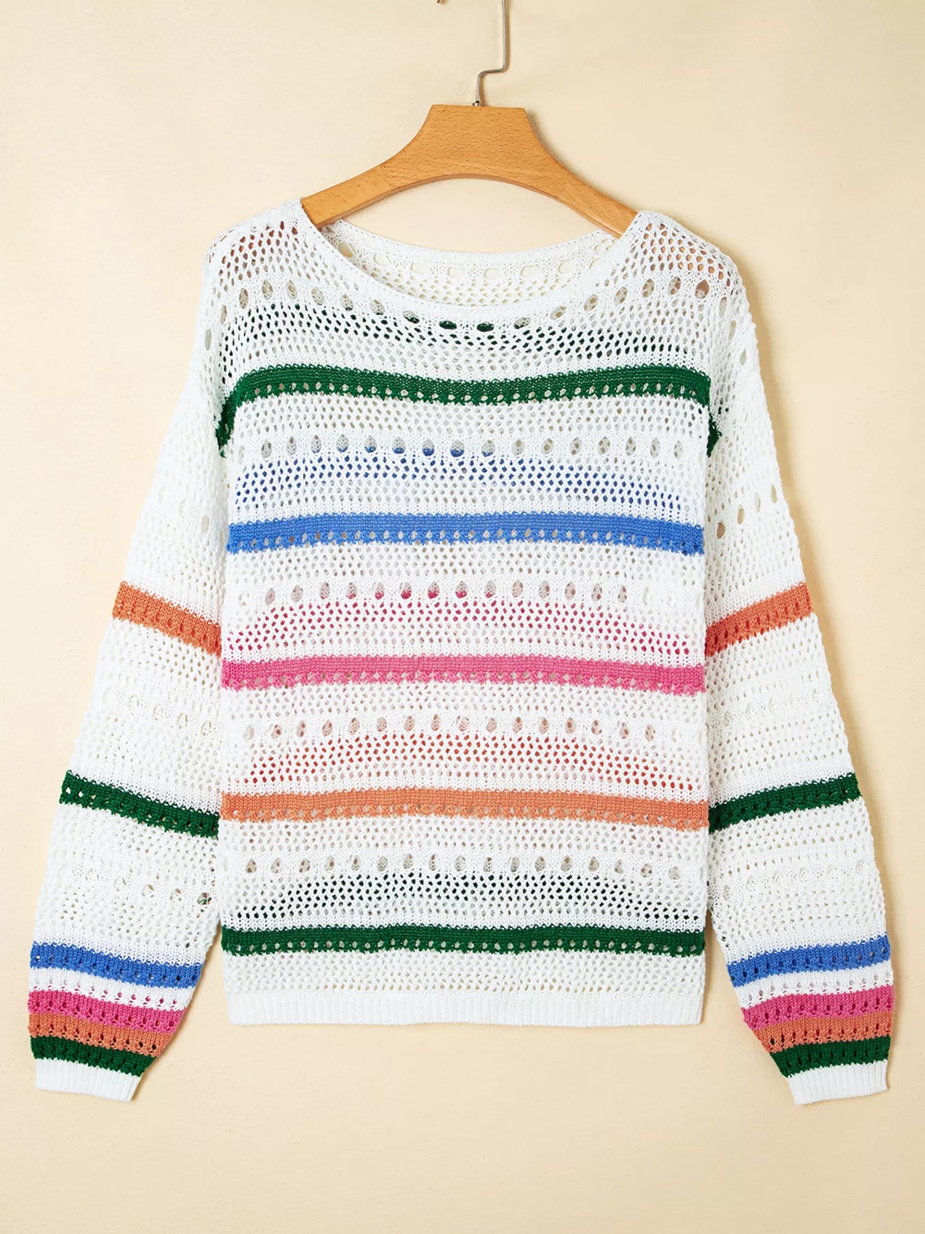 White pointelle knit sweater on hanger with multicolor horizontal stripes