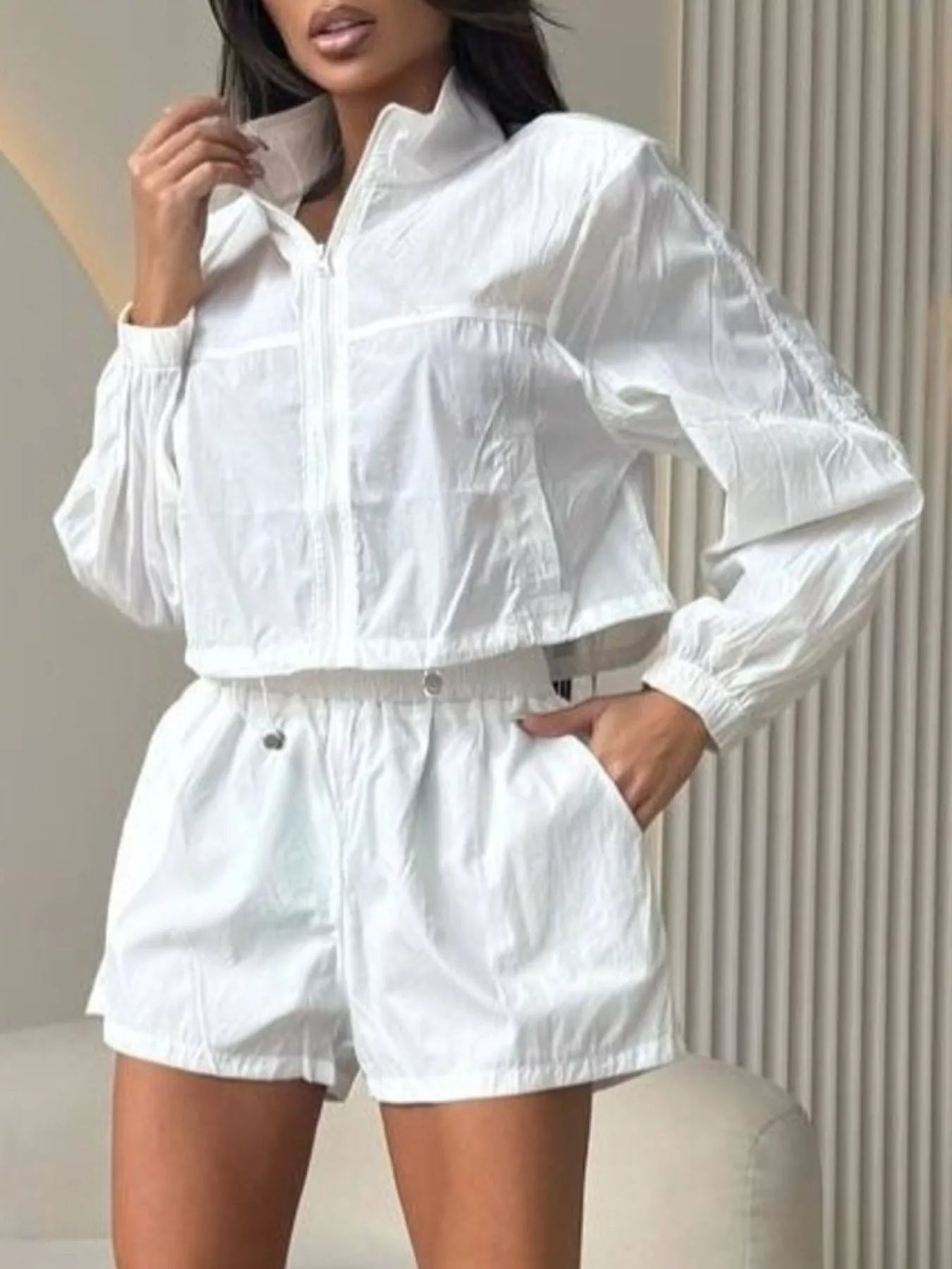 White long sleeve zip-up jacket with matching shorts, elastic waistband