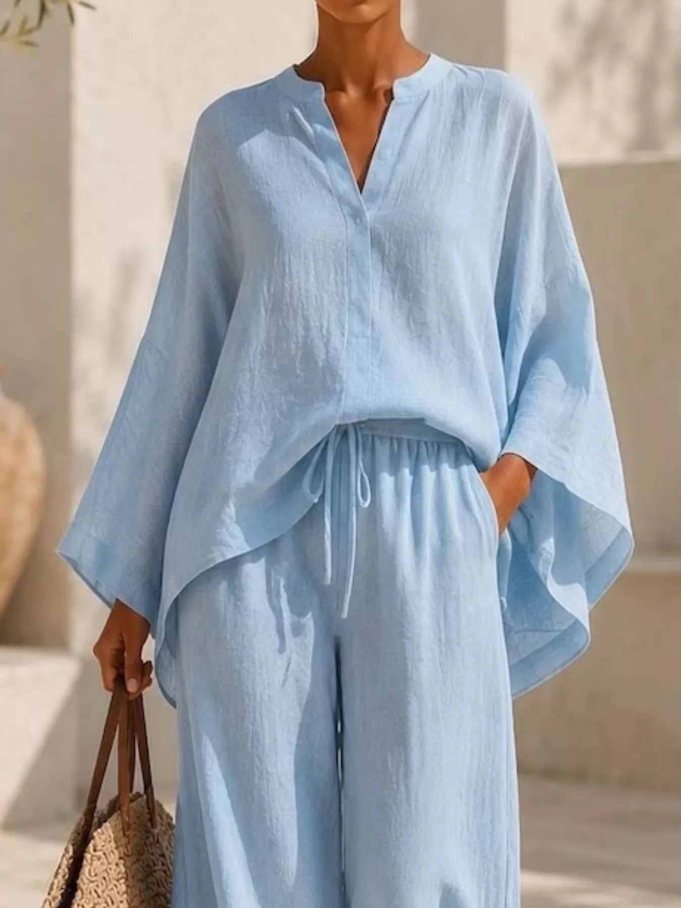 Plus-size notched long-sleeve top and wide-leg pants set in light blue, loose sleeve fit
