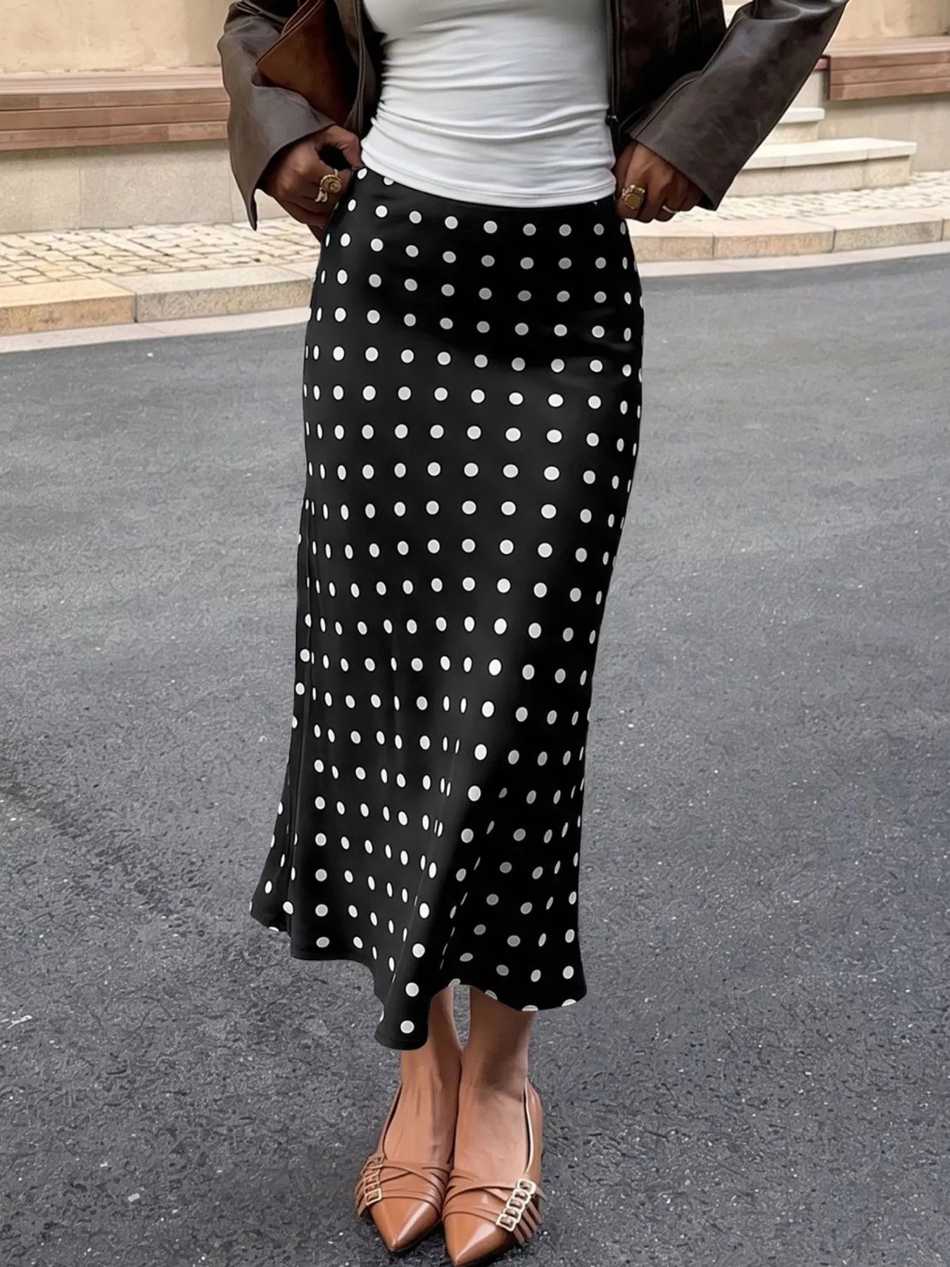 Black midi skirt with white polka dots, gathered waistband and flared hem