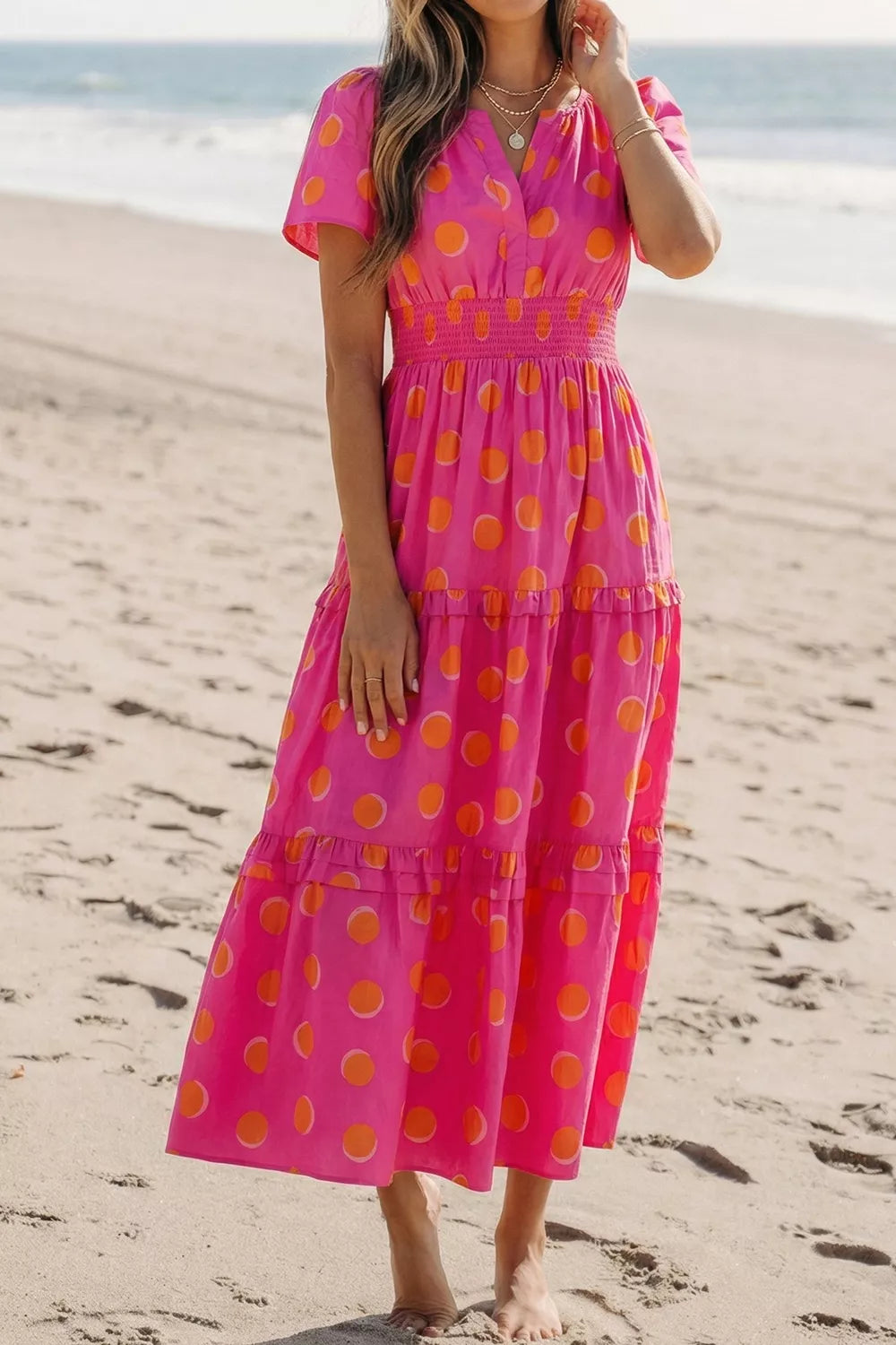 Hot pink polka dot tiered midi dress with smocked waist, short flutter sleeves