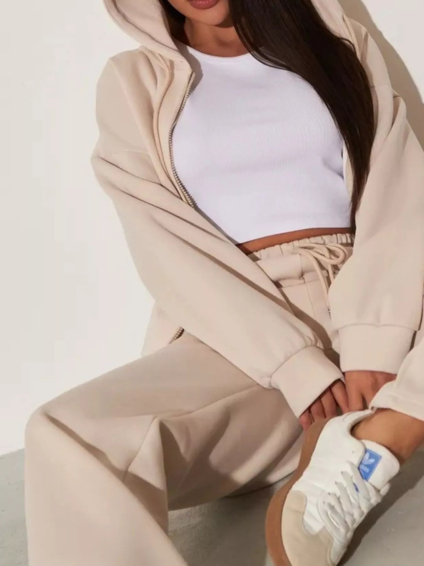 Light apricot zip-up hoodie sleeve with front pocket, paired with wide-leg pants