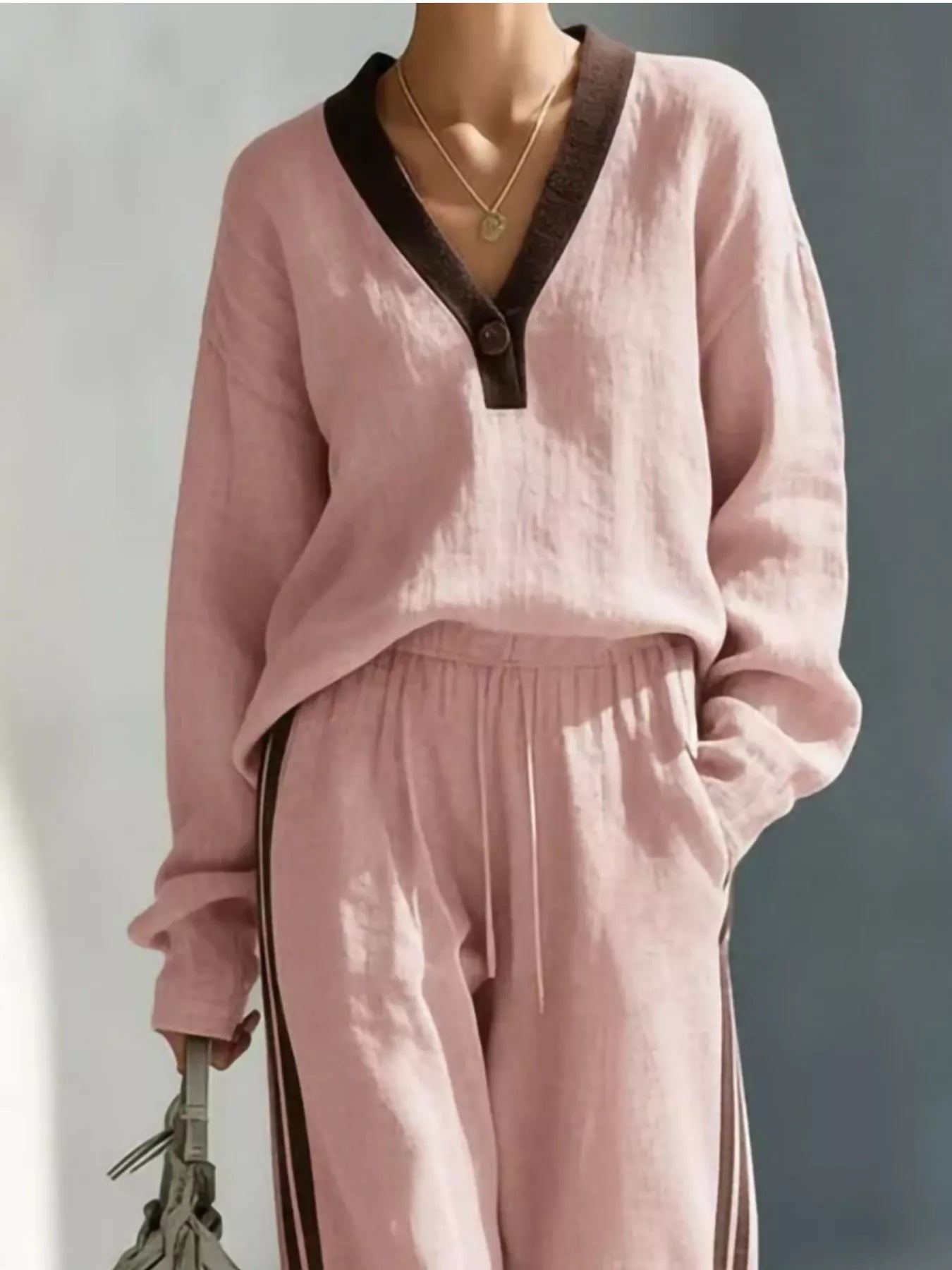 Soft pink V-neck top and striped jogger pants set with elastic waist and ties