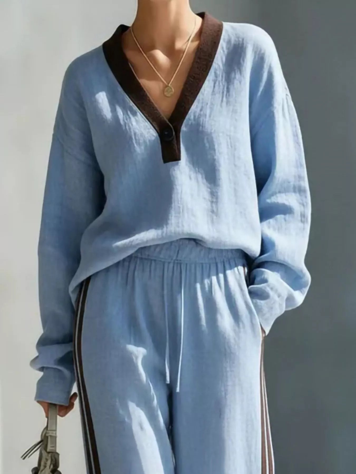 Light blue V-neck top and striped jogger pants set with contrast placket