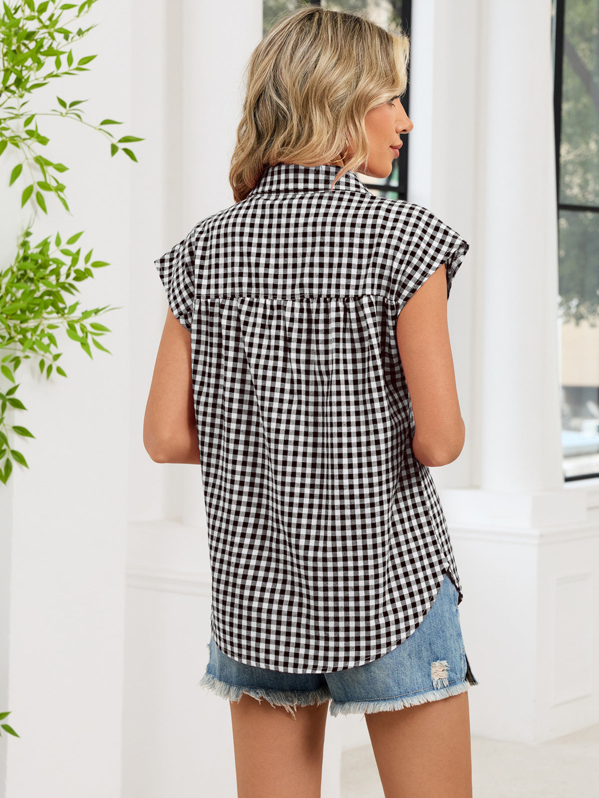Black plaid cap-sleeve button-up shirt from the back with yoke detail