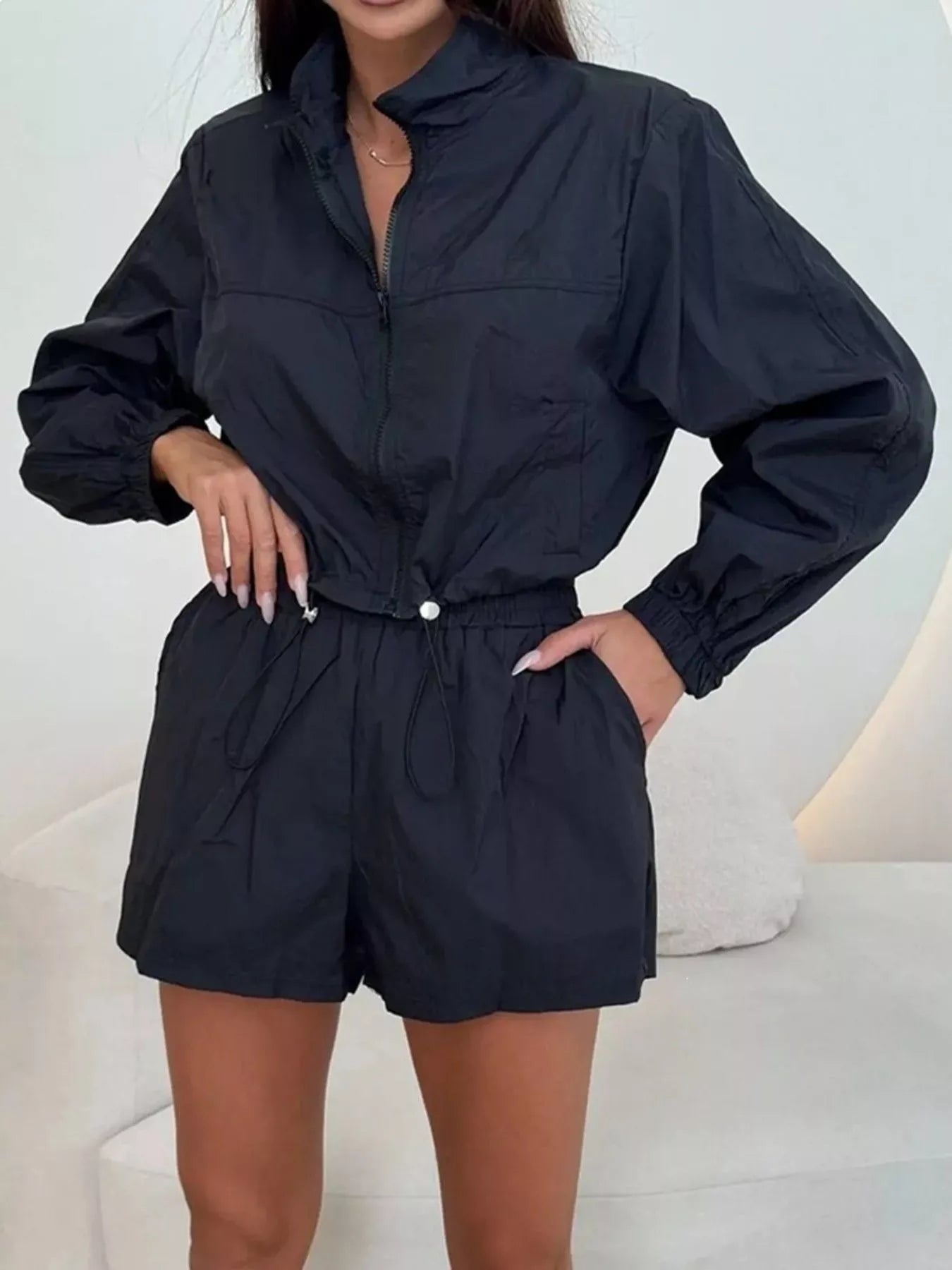 Black zip-up long sleeve jacket and elastic-waist shorts set, front view