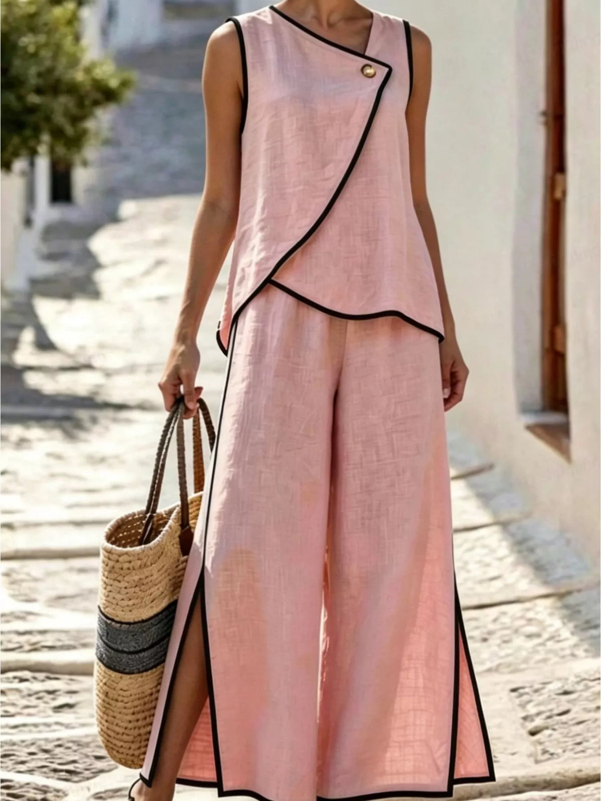 Light pink two-piece sleeveless top and wide-leg slit pants set with black contrast trim