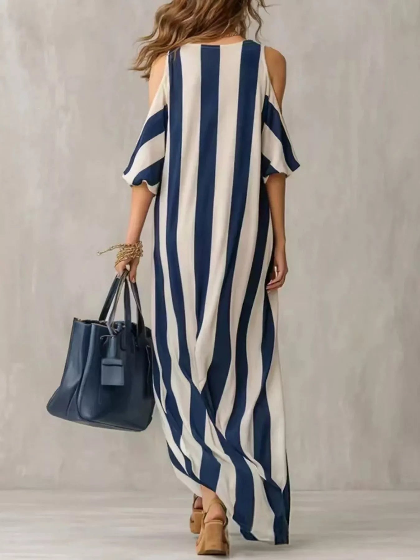 Striped cold-shoulder maxi dress with navy-and-cream vertical stripes and open shoulders