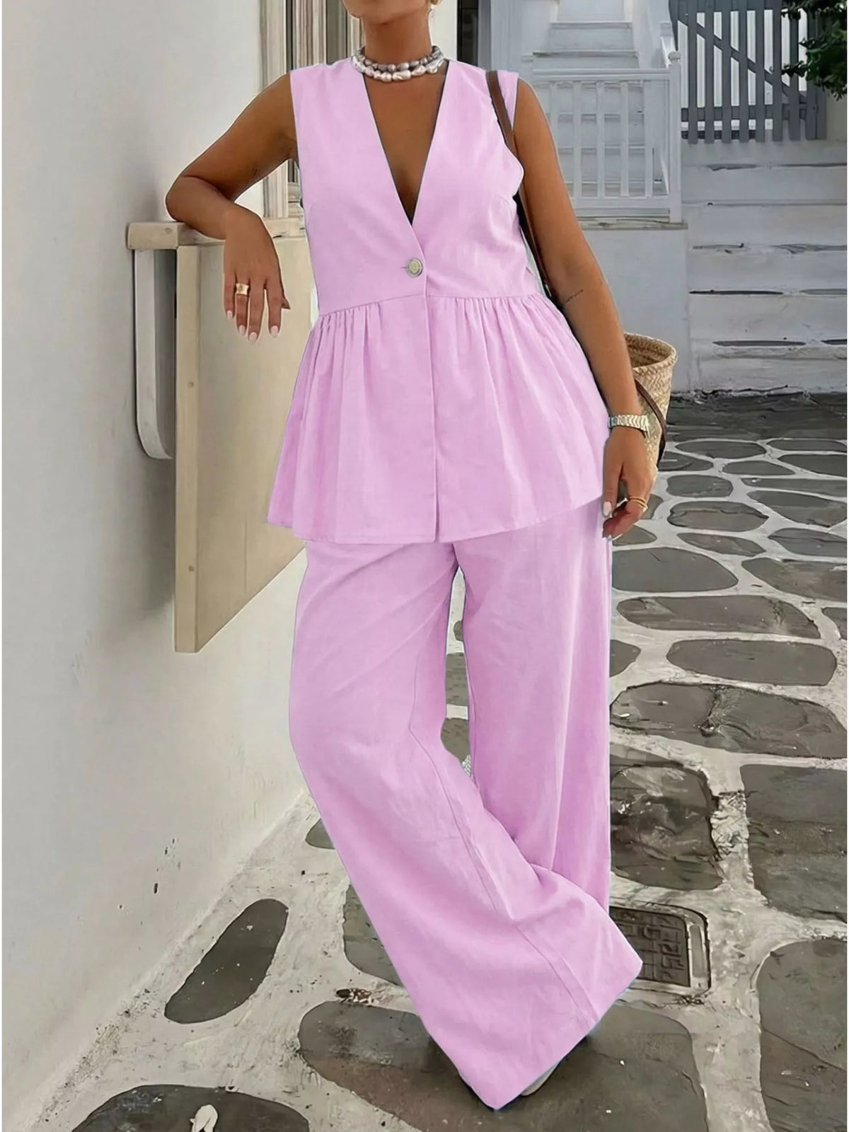 Pink V-neck sleeveless peplum top and wide-leg pants set, front close angle