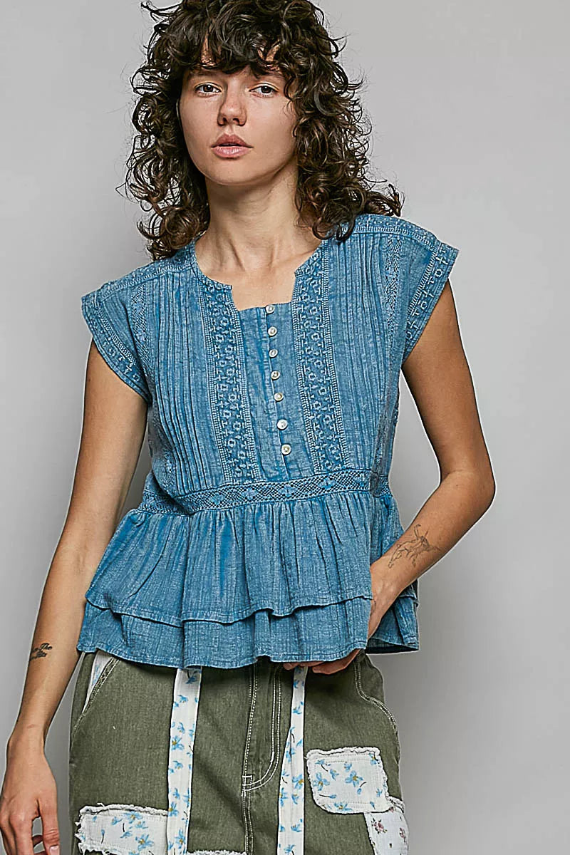 Denim blue sleeveless cotton blouse with pintuck texture, eyelet embroidery, button front