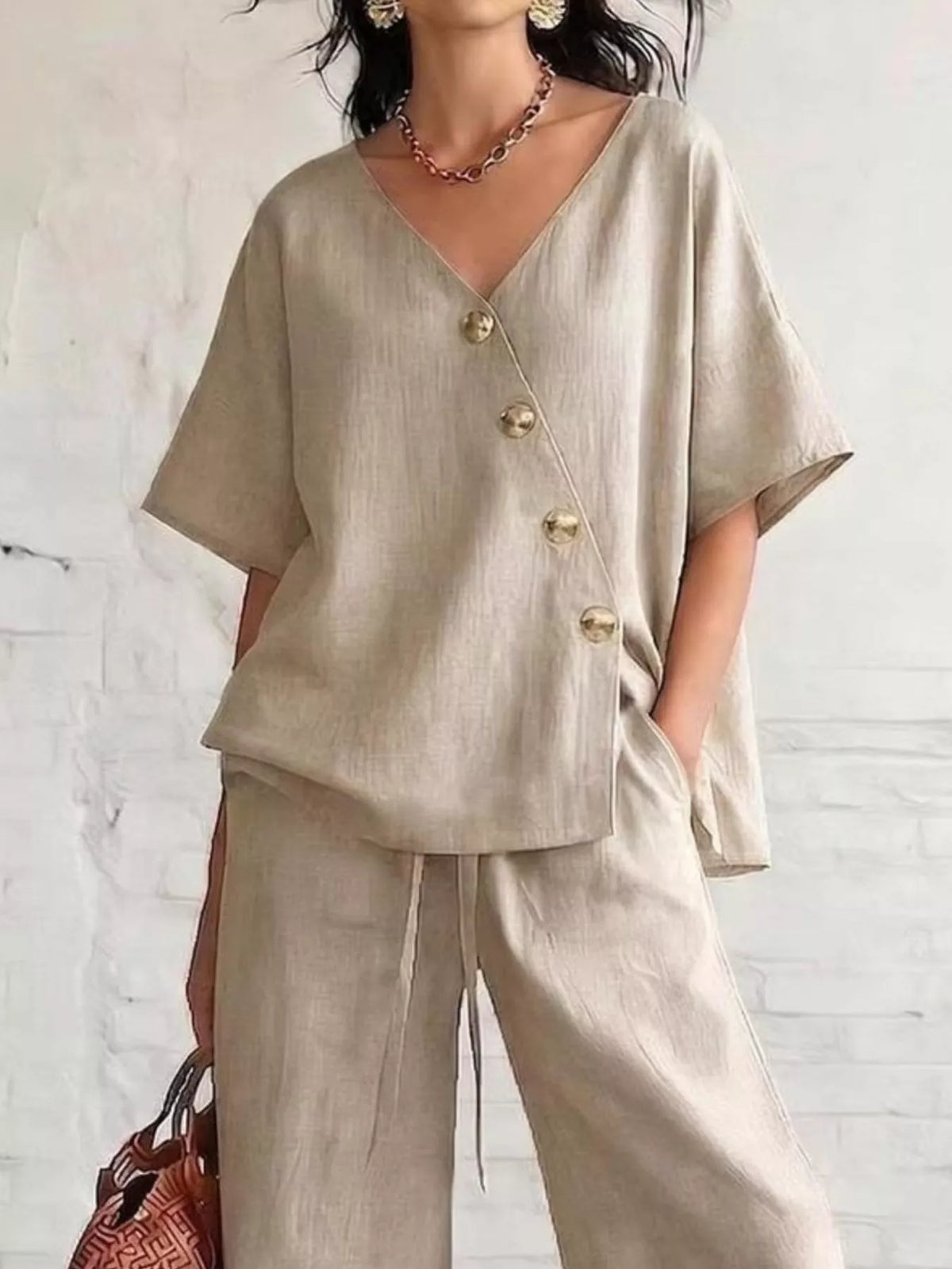 Beige surplice button-front half-sleeve top with wide-leg pants, V neckline