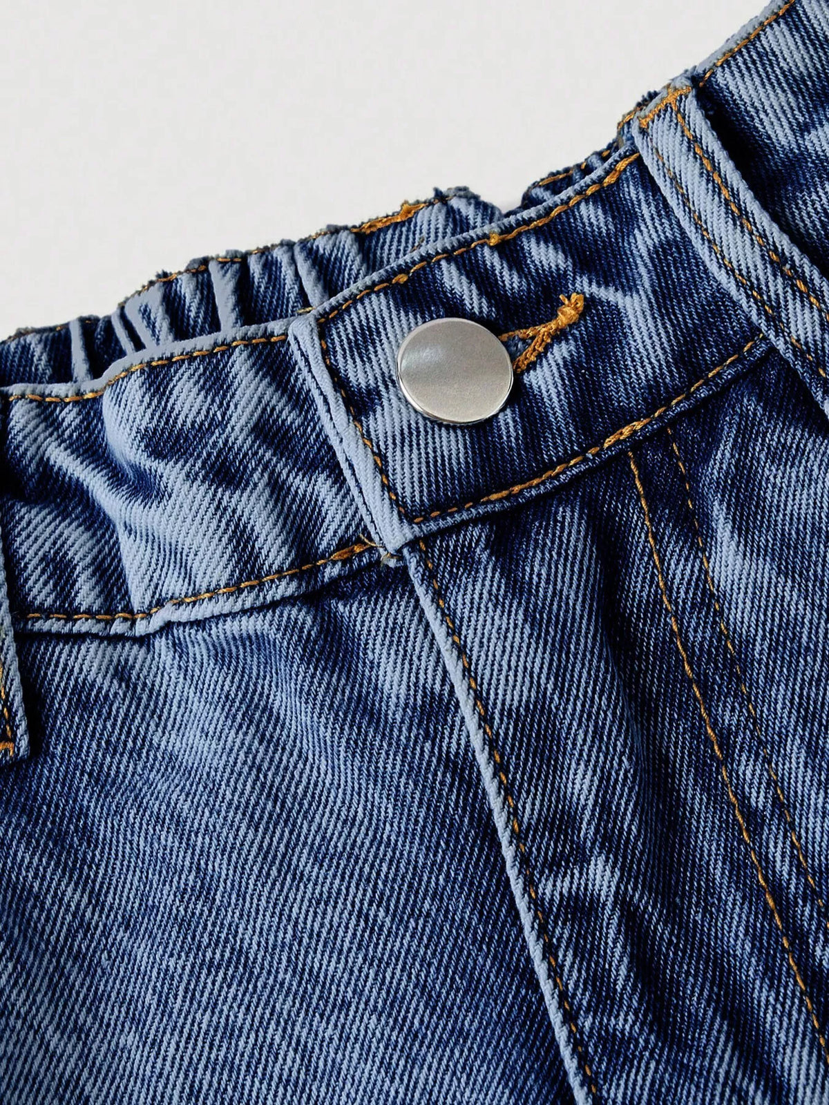 Blue denim jeans waistband with button fly and stitched belt loops