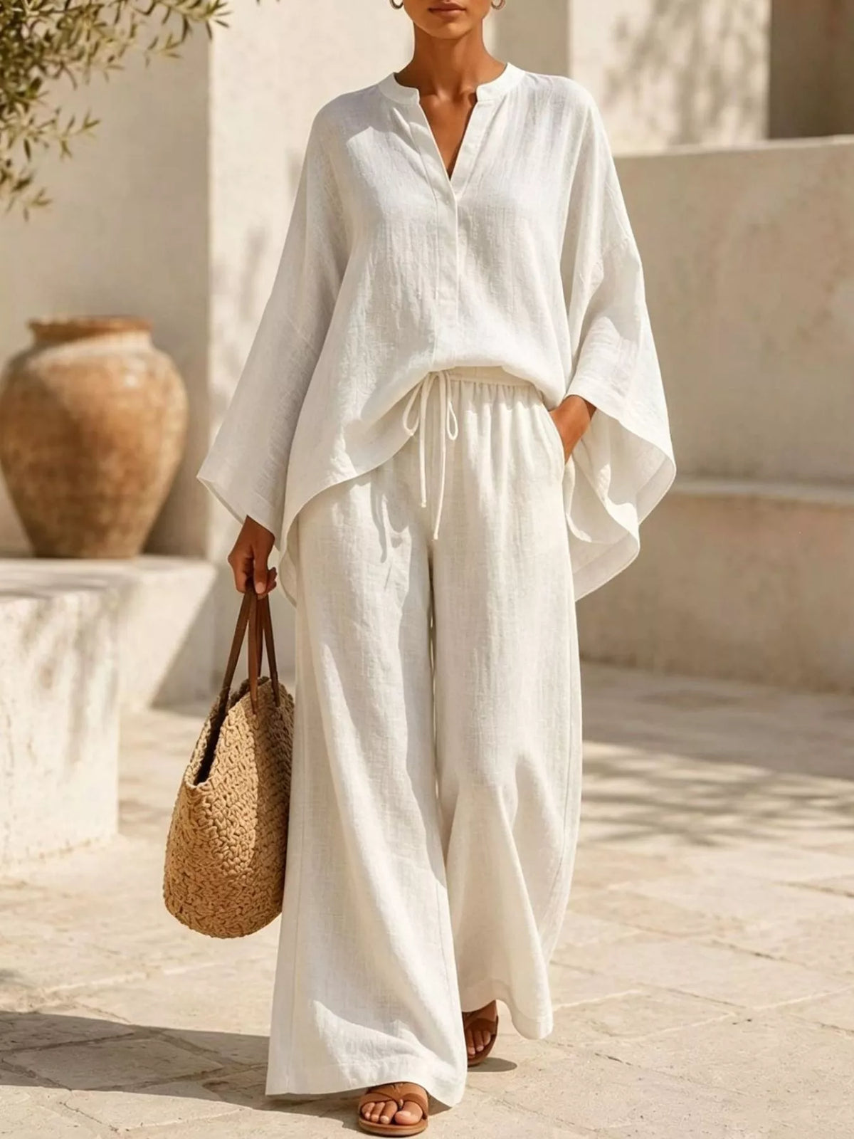 Plus-size notched long-sleeve top and wide-leg pants set in white, flowing wide-leg silhouette
