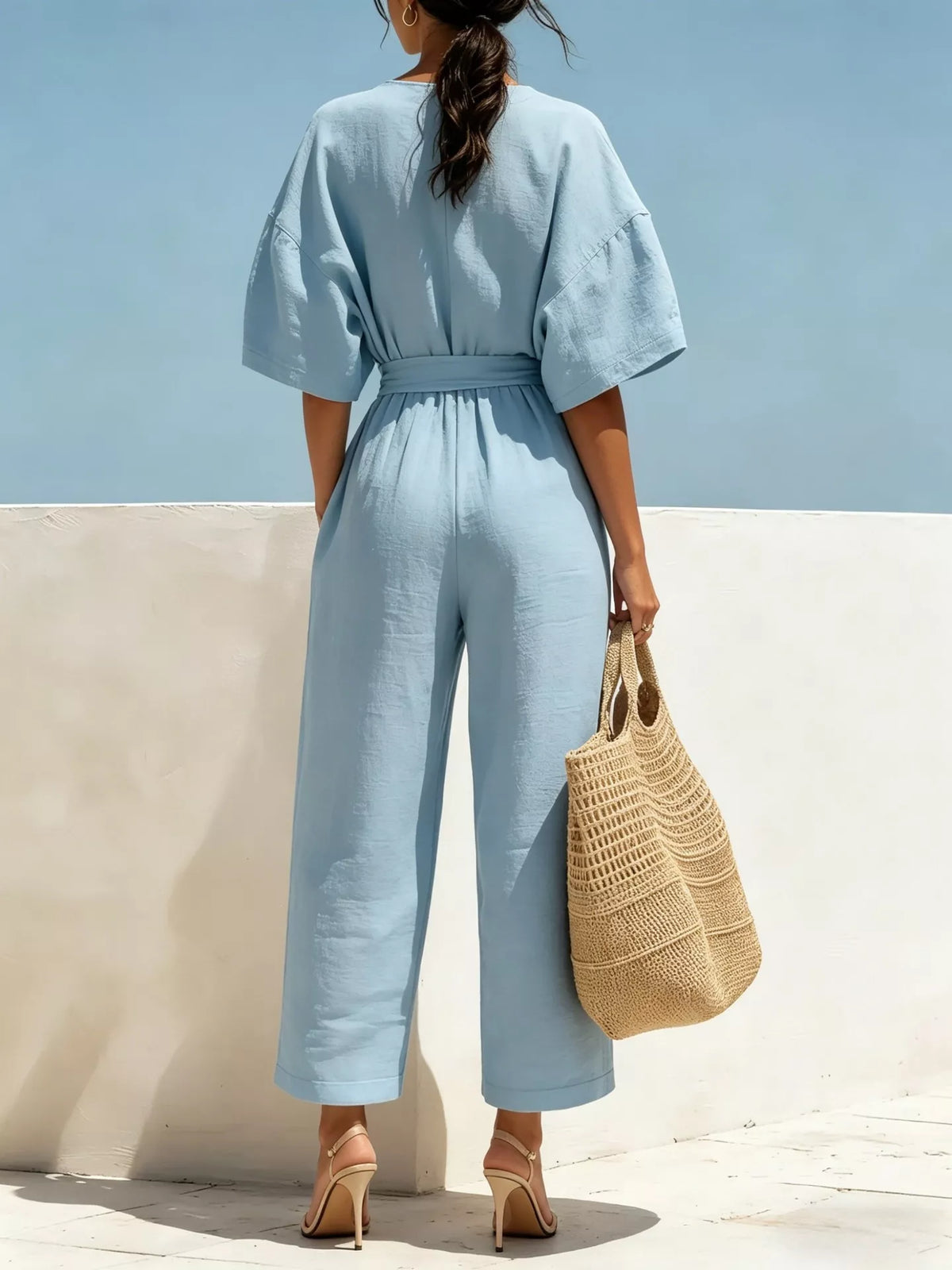 Sky blue tie-waist wide-leg jumpsuit with V-neck and loose fit short puff sleeves