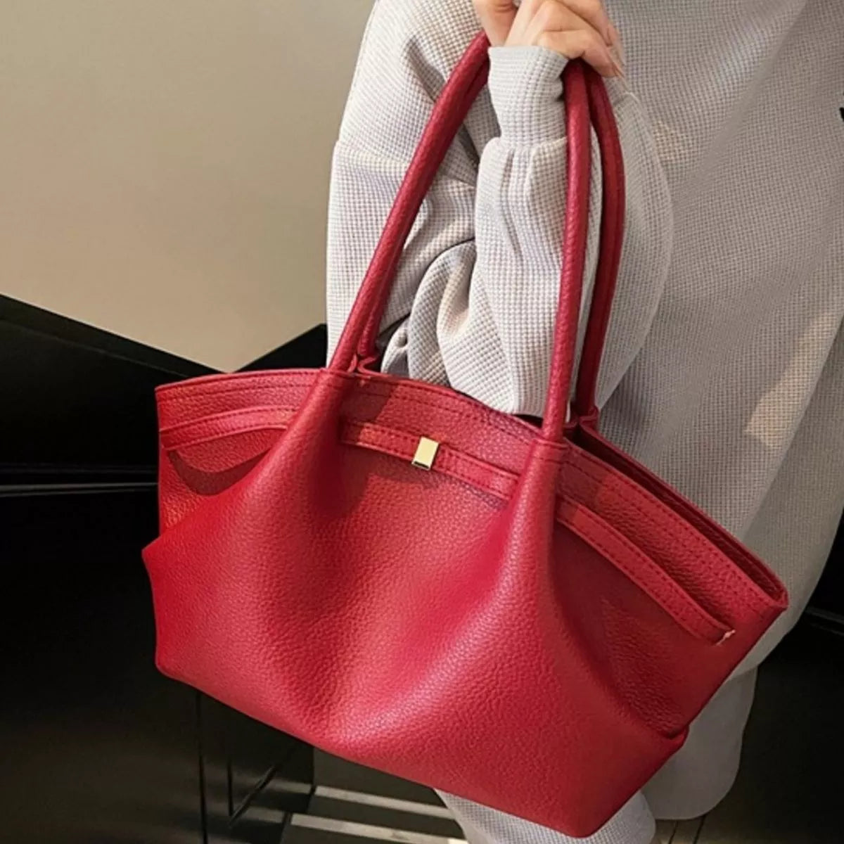 PU leather shoulder bag in red with top handles, front pocket, and zip closure