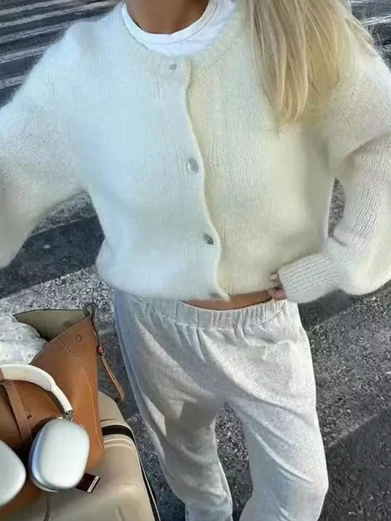 Off-white button-up long sleeve cardigan with button placket and ribbed sleeves
