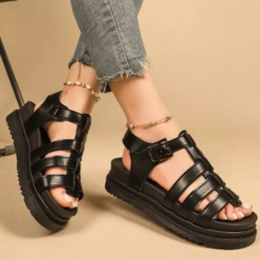 Black open-toe platform sandals with wide crisscross straps and buckles