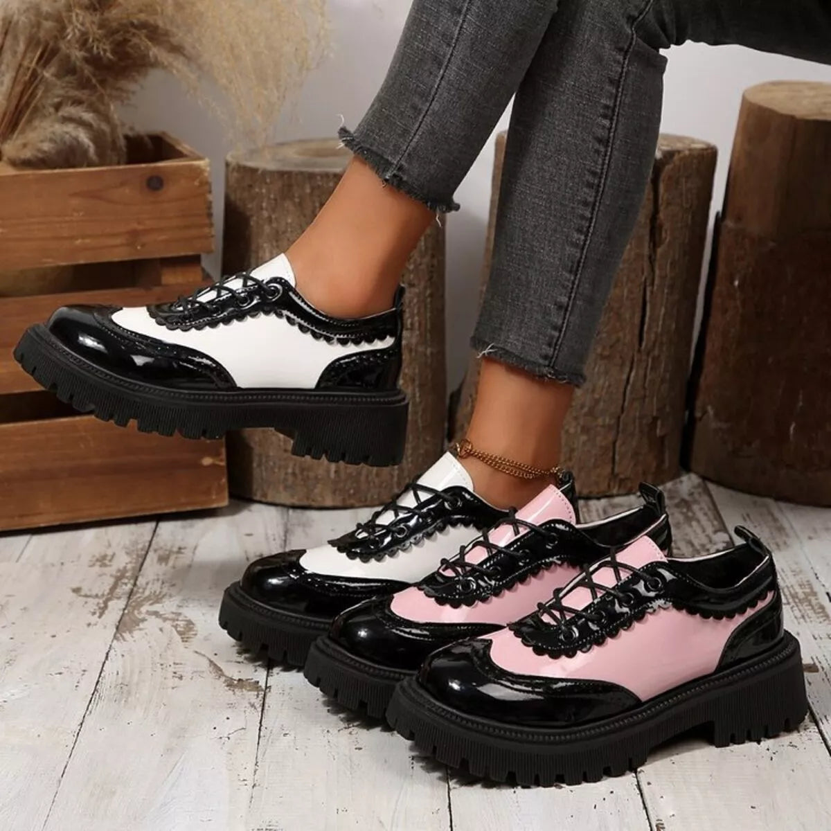 Platform loafers with black, white, and pink panels, rounded toe, thick tread sole