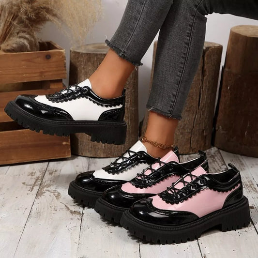 Platform loafers with black, white, and pink panels, rounded toe, thick tread sole