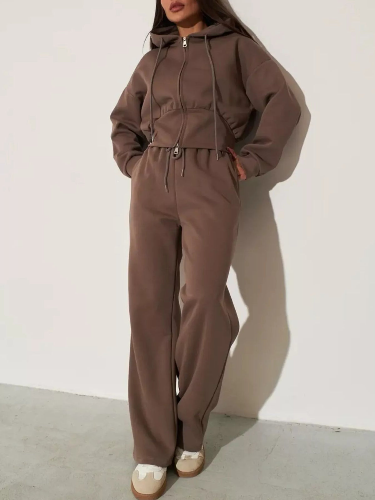 Brown zip-up hoodie and wide-leg pants set with hood and drawstring ties at the waist