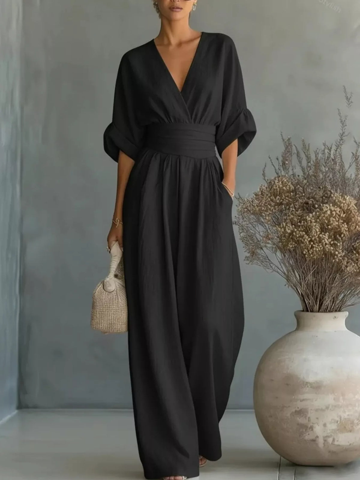 Black plus size jumpsuit with V-neck, half sleeves, elastic waist, wide pant legs