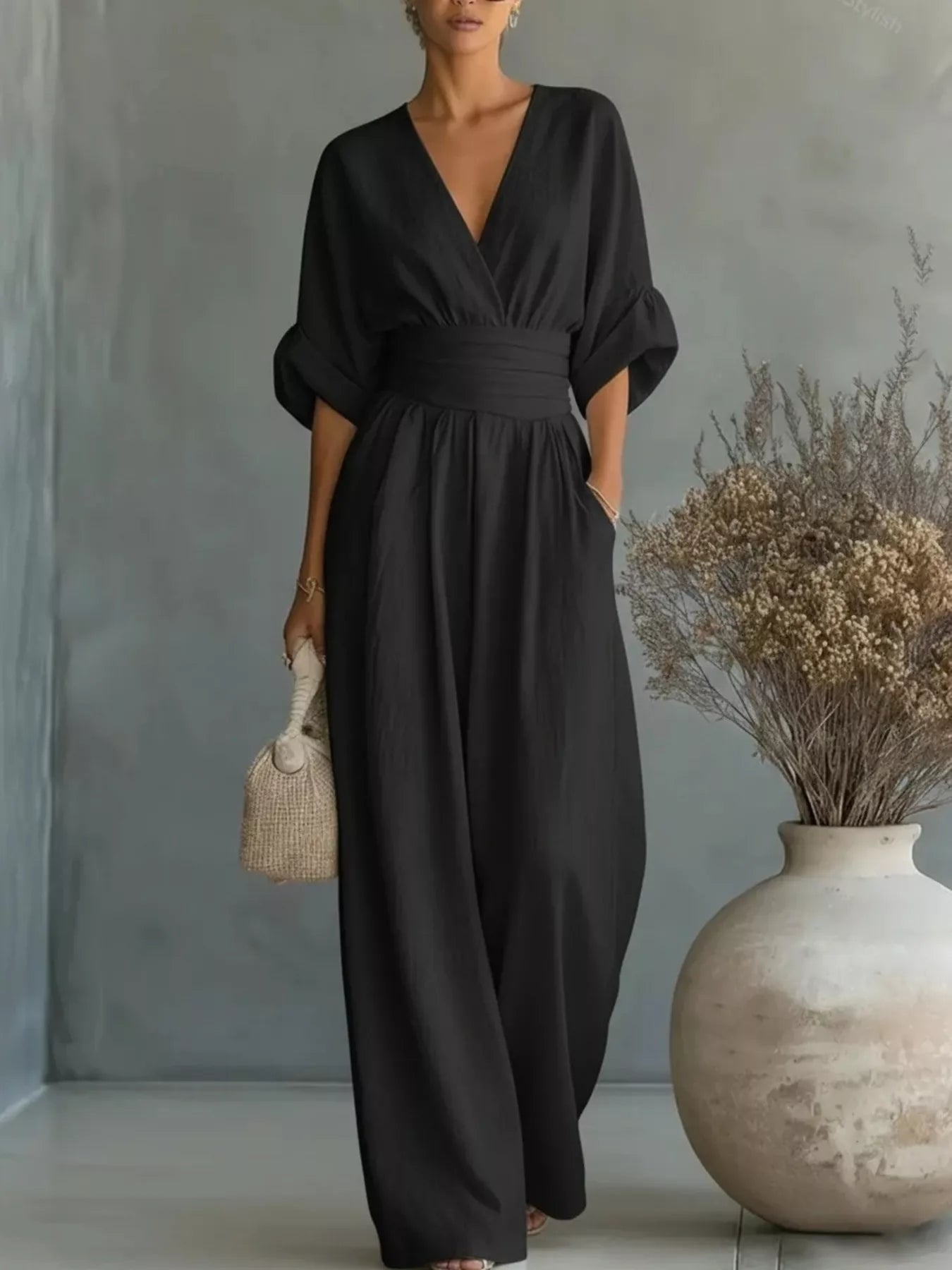 Black plus size jumpsuit with V-neck, half sleeves, elastic waist, wide pant legs