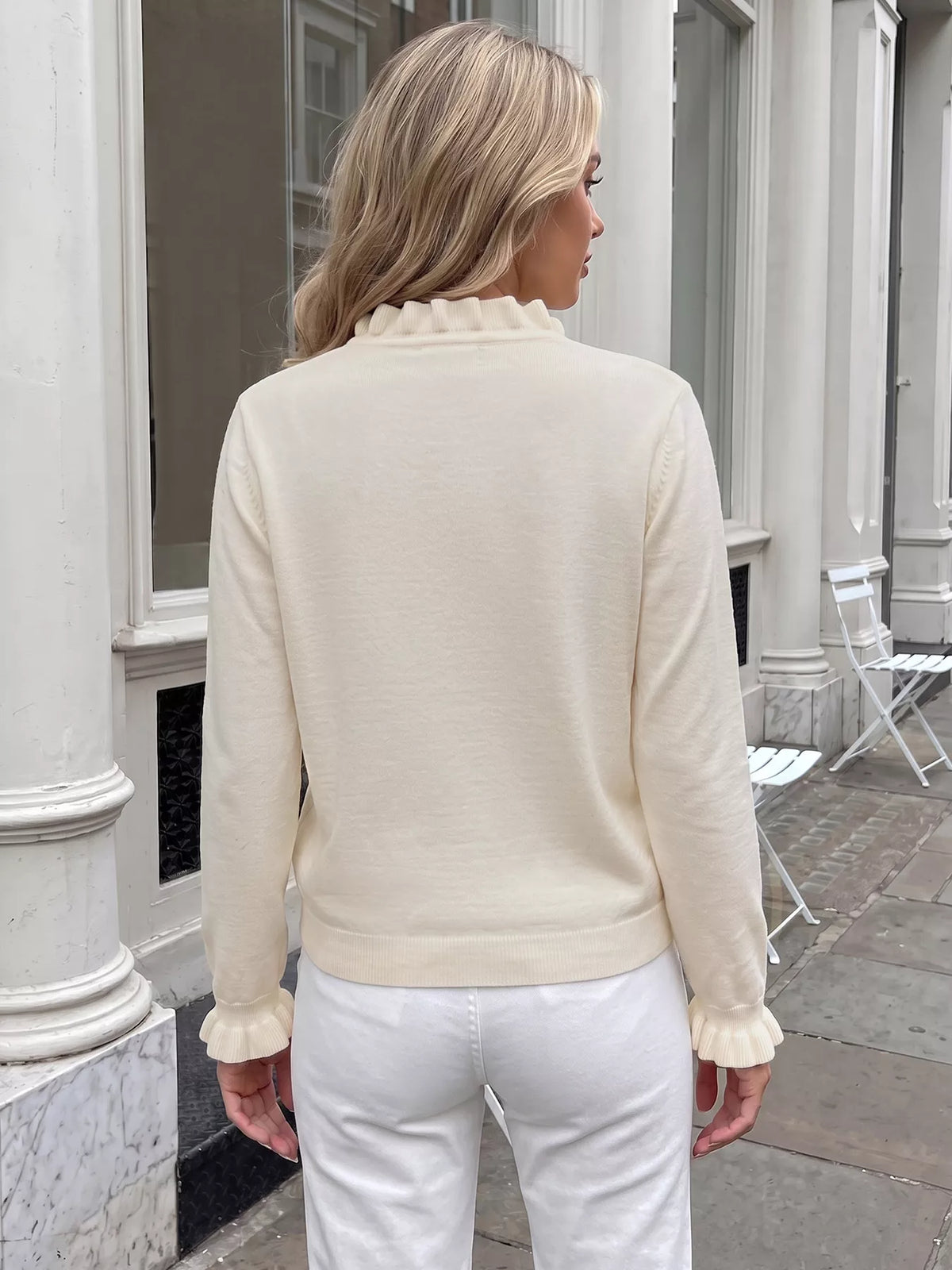 Cream long-sleeve knit top, back view, with ribbed hem and cuffs