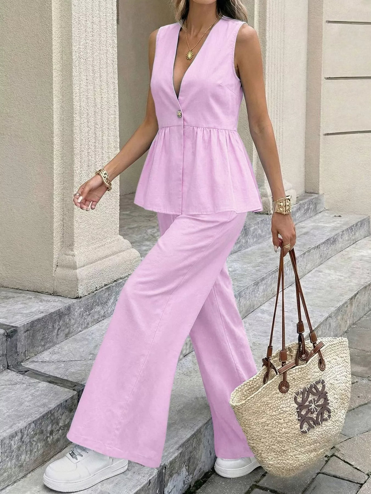 Pink V-neck sleeveless peplum top with wide-leg pants set, side step