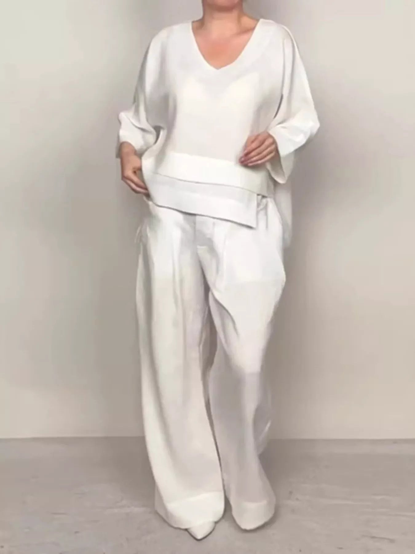 White V-neck long sleeve top and wide-leg pants set, relaxed fit with layered hem.