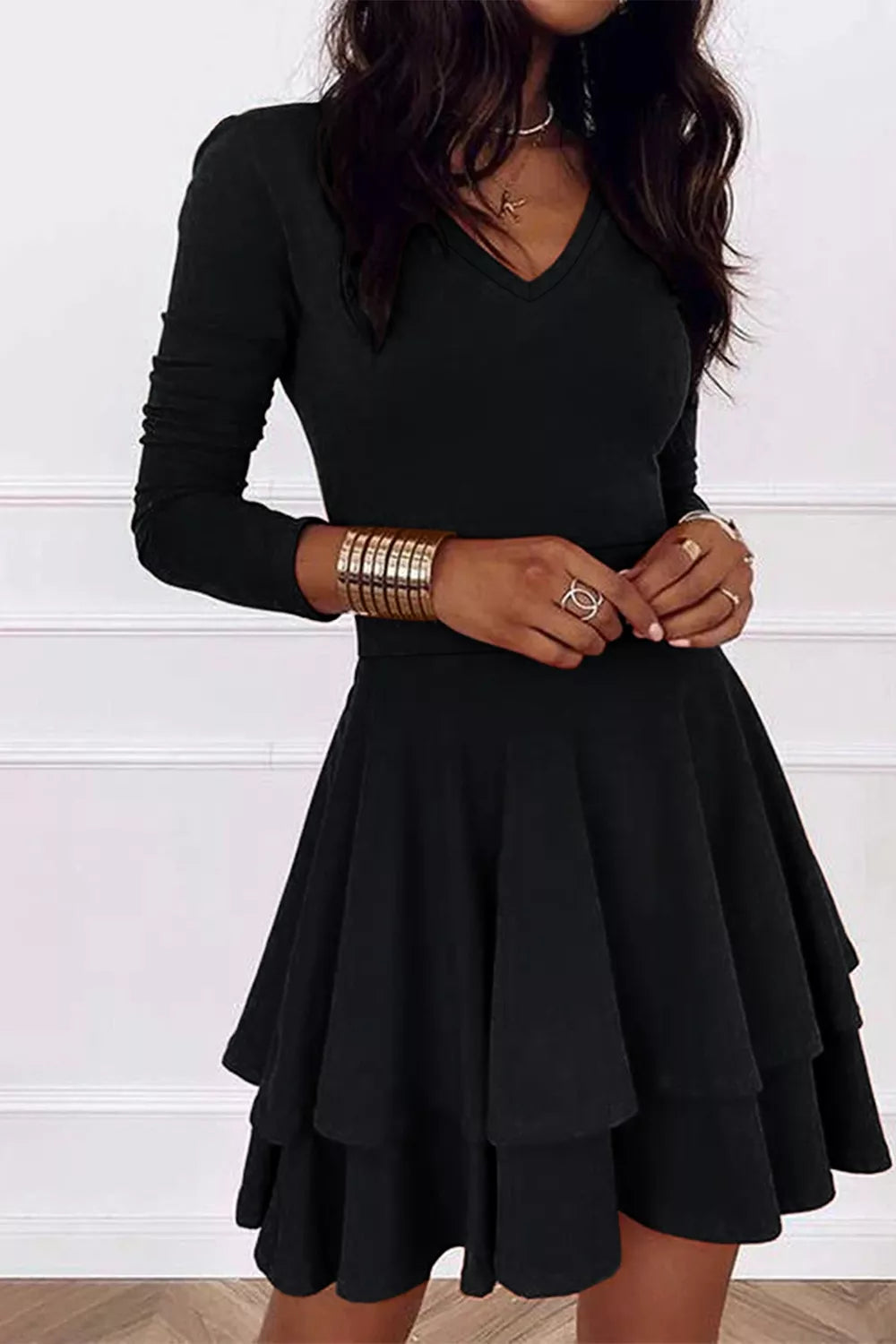 Black layered long sleeve V-neck mini dress with tiered flared skirt