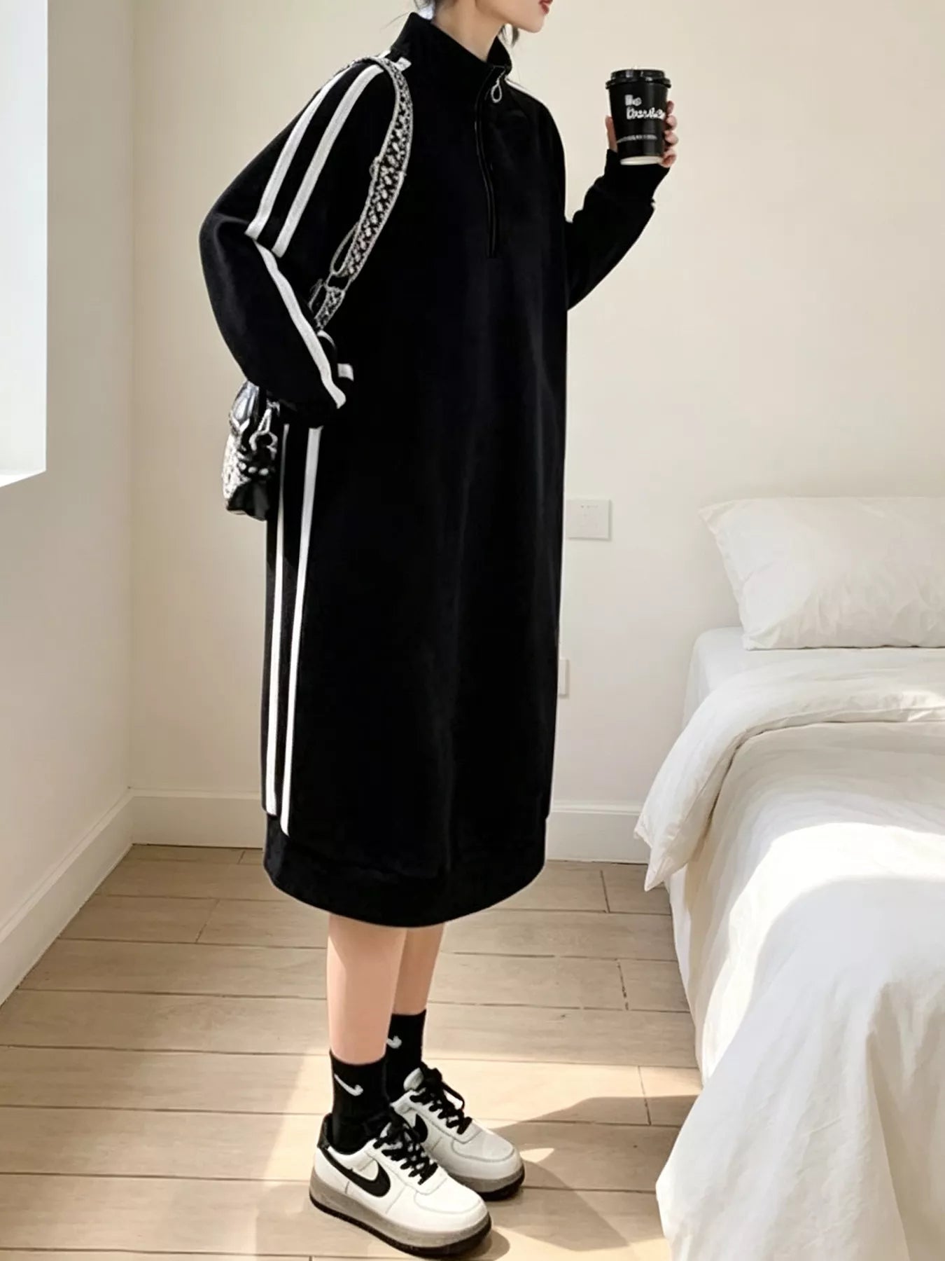 Black quarter-zip mock-neck midi sweatshirt dress with vertical white side stripes, long sleeves