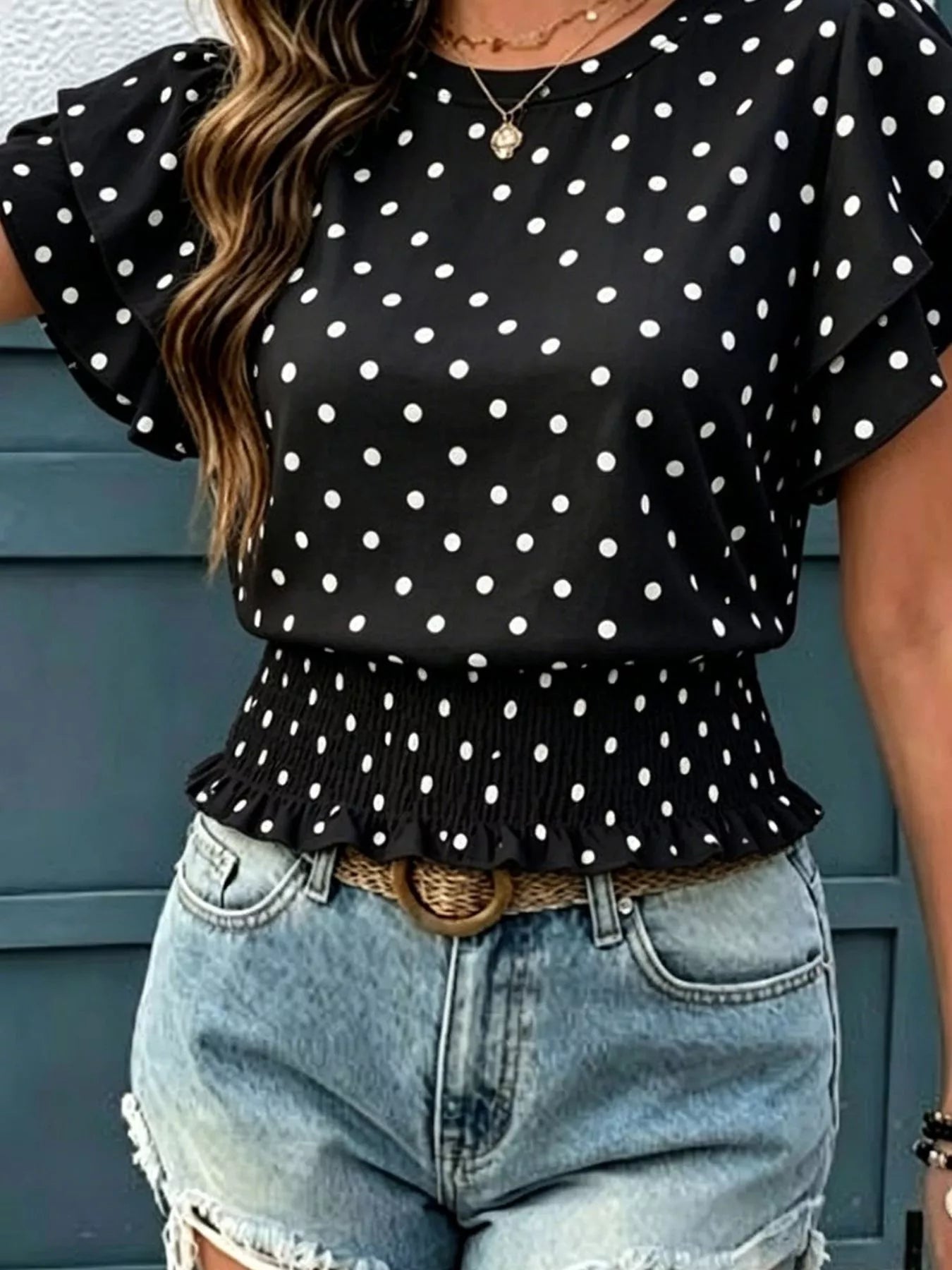 Black polka dot blouse, short ruffle sleeves and cinched peplum hem