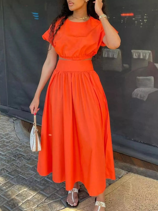 Orange red crop top and long gathered skirt set with puff sleeves, front view
