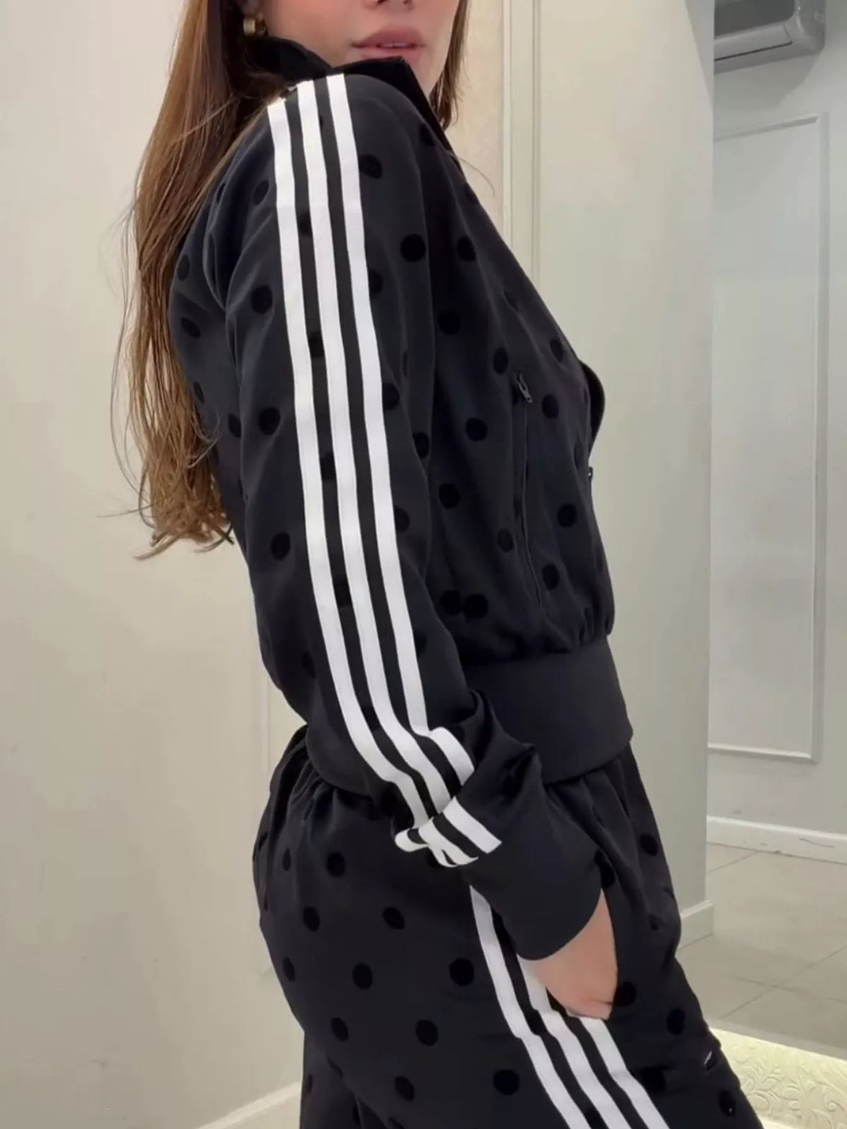 Black polka dot zip-up set with triple white stripe sleeves and matching pants
